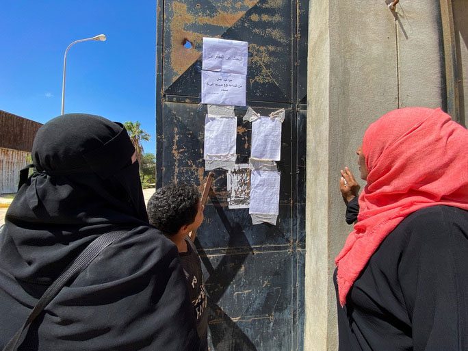 Residents of Derna checking the list of missing persons on September 14