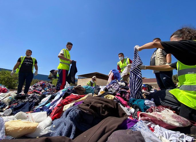 Volunteers organizing clothes to distribute to survivors