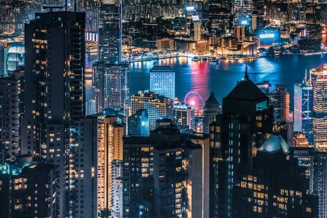 Hong Kong at night is illuminated by vibrant lights.