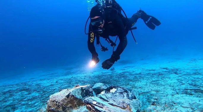 Diving teams recover the obsidian block from the seabed near Capri Island, Italy.