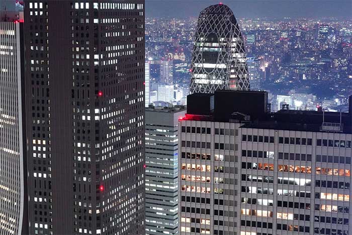 Office buildings still lit at night in Tokyo.