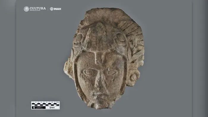 Maya warrior statue with a serpent on its head