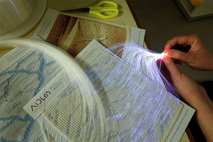 The fabric is woven with plastic optical fiber (POF) and can reflect multiple colors