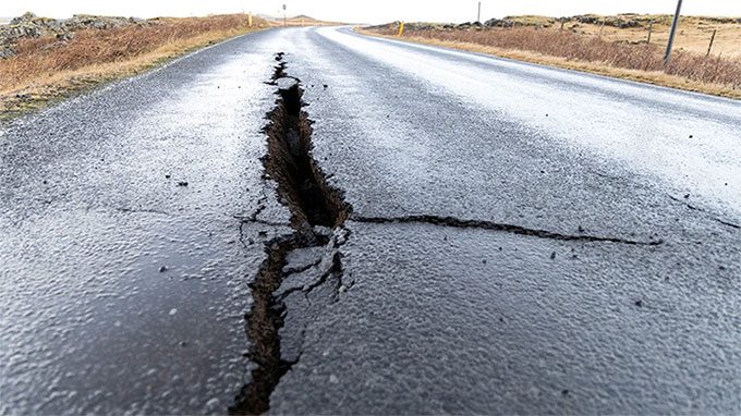 A crack in the road after seismic activity.