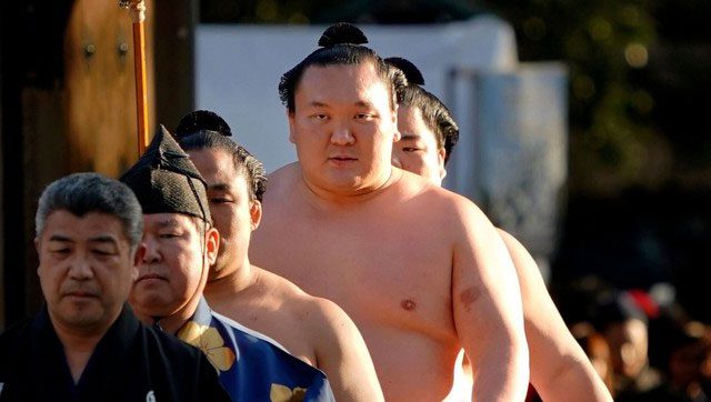 Sumo wrestlers follow strict training and dietary regimens.