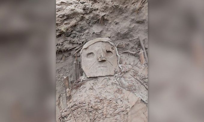 A carved mask on a mummy.