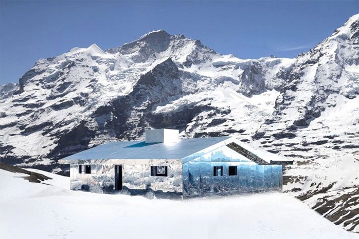 The house reflects and interacts with the mountain landscape through changing seasons.