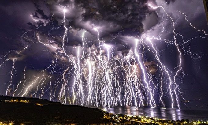 The image captures at least 3 types of lightning during the thunderstorm.