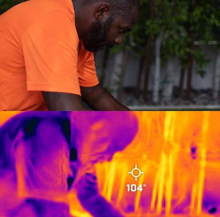 A man continues to sweat despite resting in the shade.