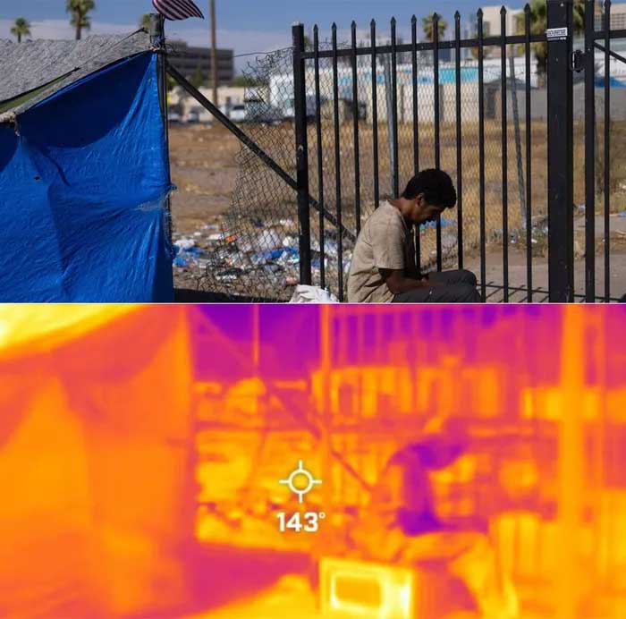 The heat of 62°C envelops a homeless man sitting next to a parking lot.