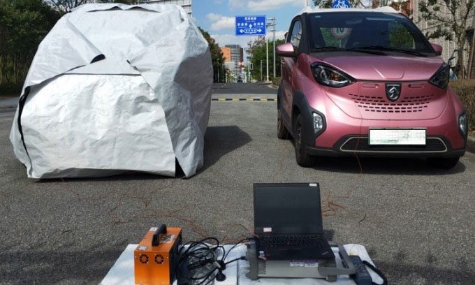 The research team testing the thermal cloak with an electric vehicle.