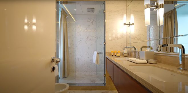 Next to it is a closet space, opening the door leads to a spacious bathroom