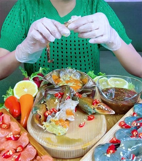 A TikToker showcasing a gigantic meal with many live food items.