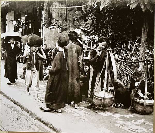 Women selling food on street carts before 1932.