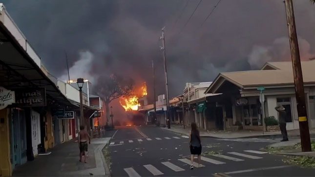 Fire engulfs a street on Maui Island.
