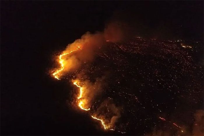 The fire spreads, engulfing the island due to strong winds.