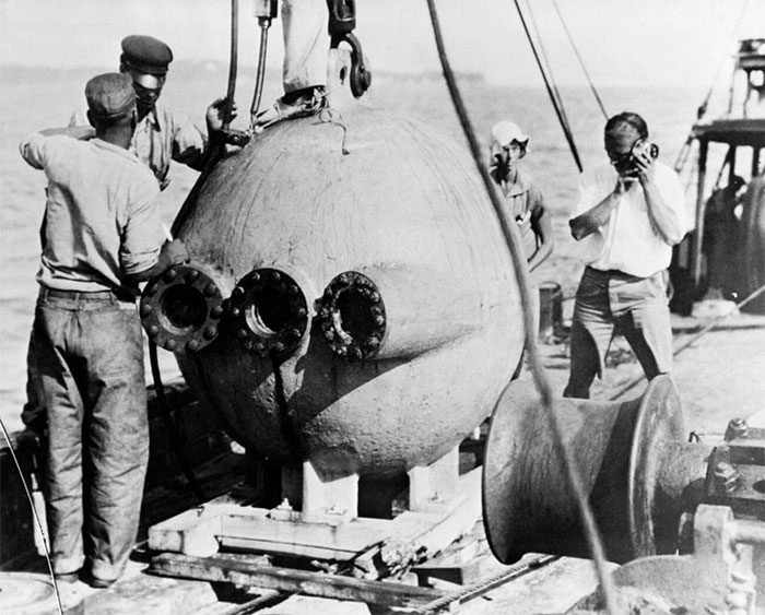 Divers descended into the ocean in a spherical submersible (Bathysphere)