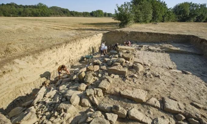Experts excavating the entrance to the ancient city beneath the dried-up Ullastret Lake.