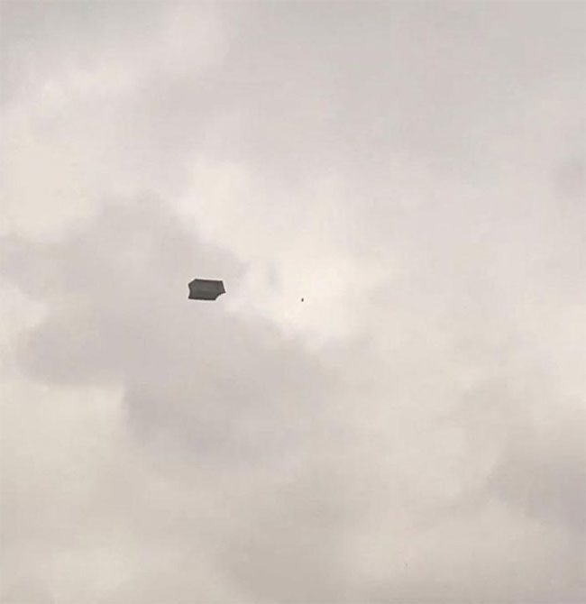 The sofa soaring into the sky.