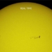 international space station flying over the dark spot on the wide sun 128096