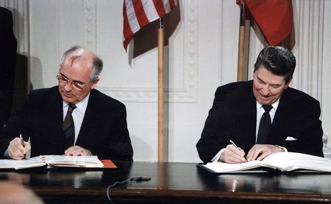 Mikhail Gorbachev (left) and Ronald Reagan signing the Intermediate-Range Nuclear Forces Treaty