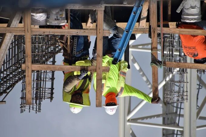Workers performing tasks upside down as perceived by Patient M.