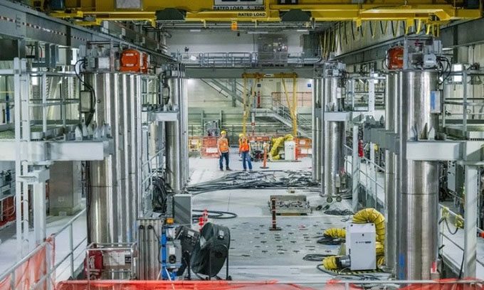 Workers at Hanford stand near the first melter.