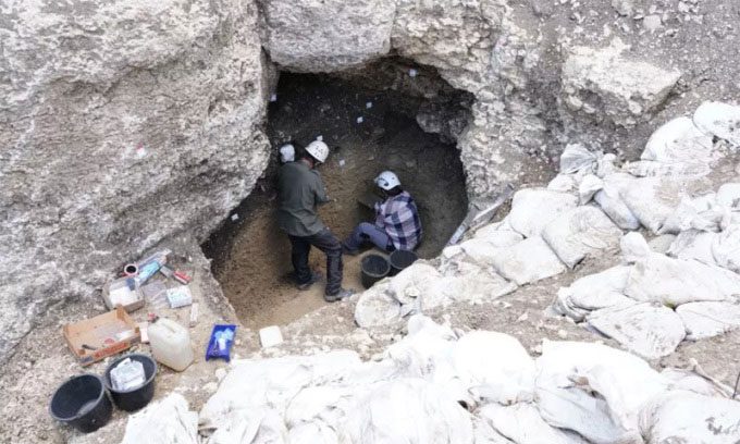 Archaeologists exploring the original entrance of the Ice Age cave in Germany.