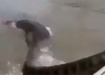 man uses hands to handle giant monster on river 127815