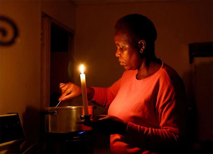 Maria Modiba cooking by candlelight due to power outages