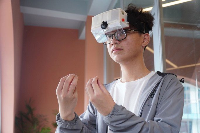 Nguyễn Minh Nhật Huy and the AI-integrated glasses model supporting communication for the hearing impaired.