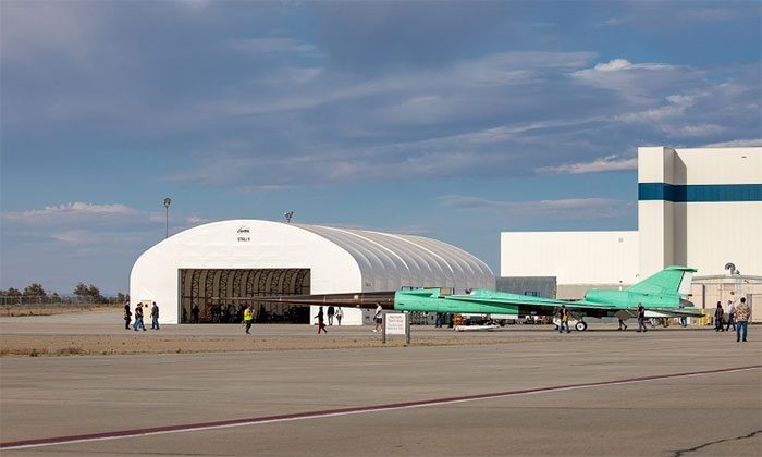 The X-59 aircraft rolls out of the hangar.