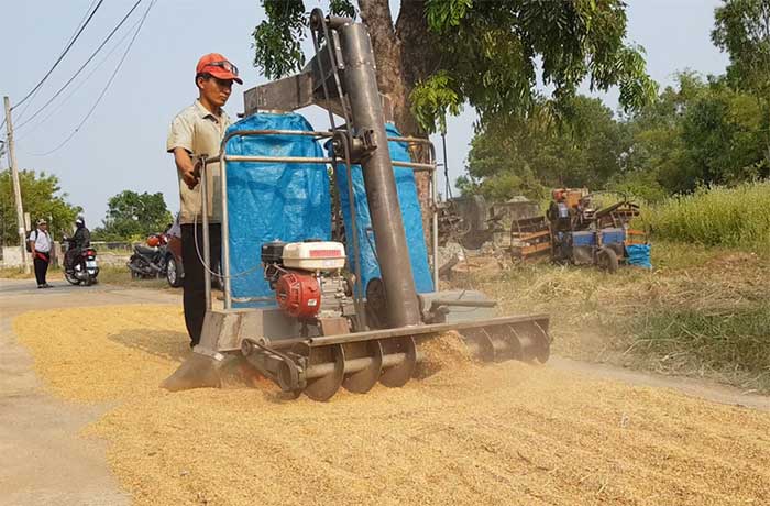 Mechanic Nguyen Ngoc Tri testing his rice harvesting machine