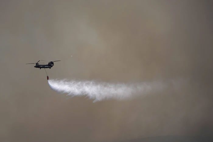 A military helicopter drops water on a fire in the village of Pournari near Athens on July 18.