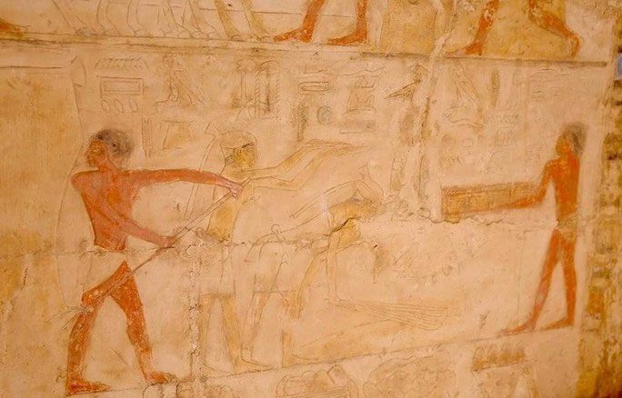 A relief depicting a step in the embalming process