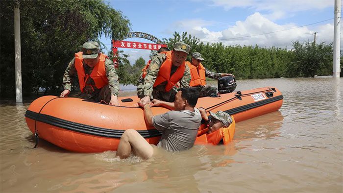 Rescue workers pulling a citizen from floodwaters in Harbin on August 5.