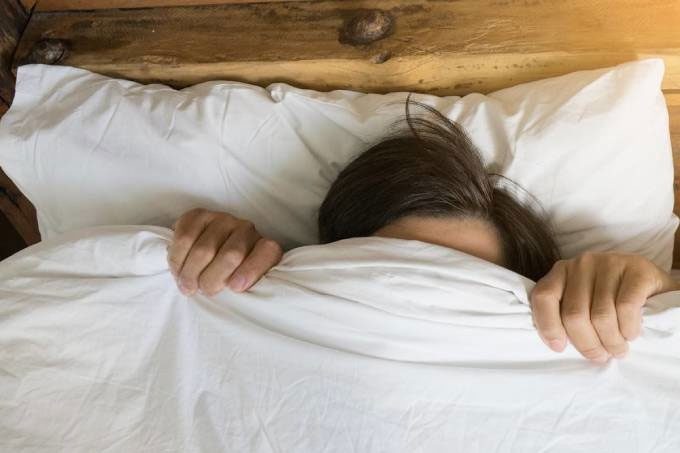 Covering the head while sleeping risks oxygen deprivation in the brain.