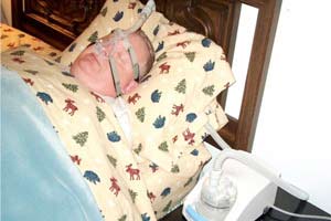 A person with sleep apnea using a ventilator while sleeping