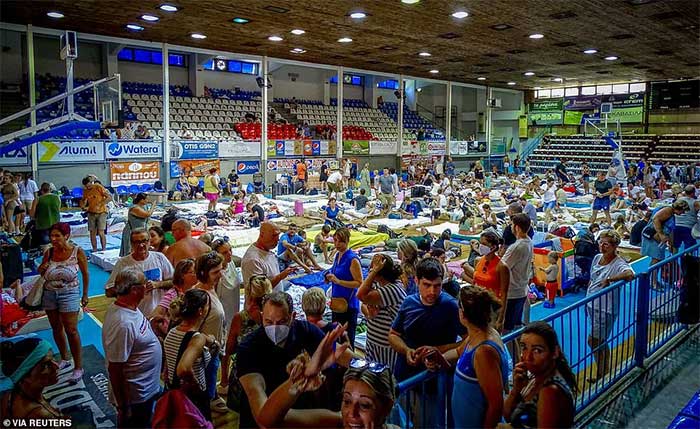 Tourists and residents taking refuge in a sports hall on Rhodes