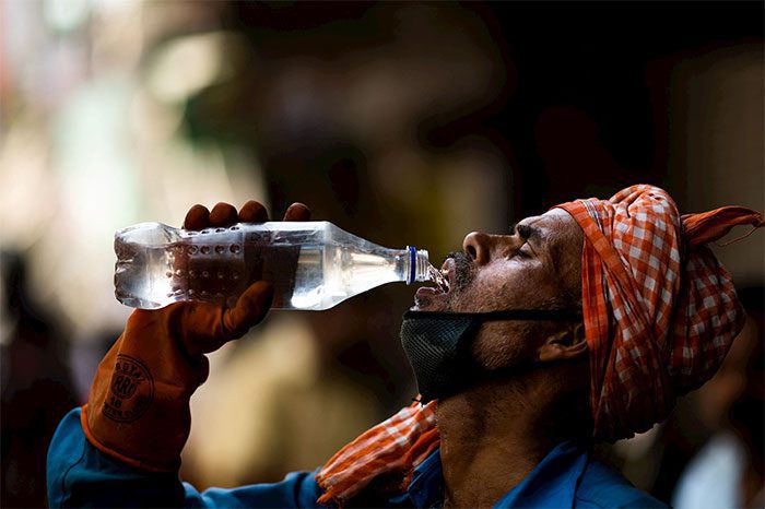A worker quenching thirst on the streets amidst rising temperatures in New Delhi.