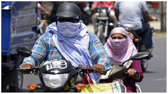 A pedestrian covering their head to avoid the heat in Amritsar, India.