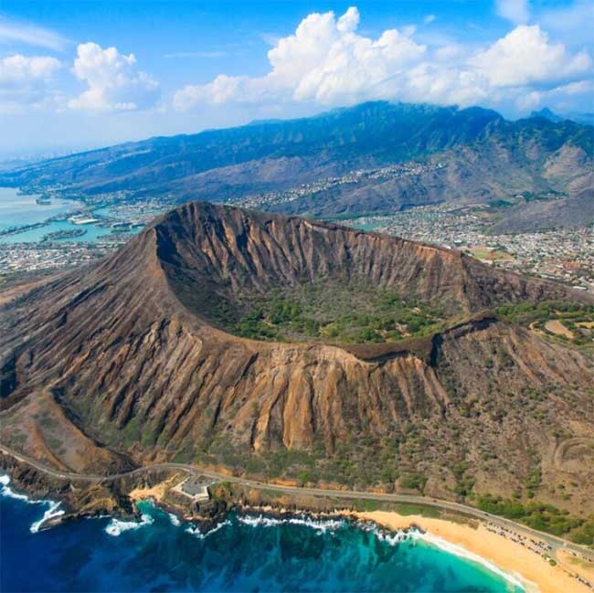 The volcano is covered in vibrant greenery.