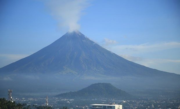 Mayon Volcano is erupting ash and large rocks.