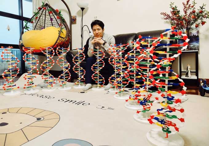 Associate Professor Nguyen Tuan Anh beside a DNA model.