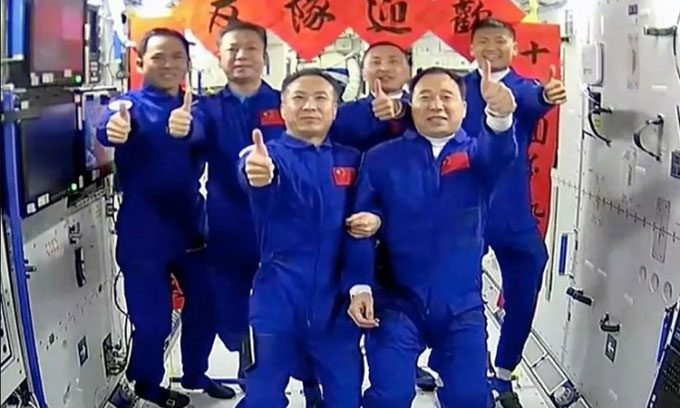 Shenzhou 15 and Shenzhou 16 astronauts take a photo on the Tiangong station.