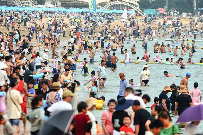 People flock to the beach amid the heatwave in Qingdao, Shandong province, China.