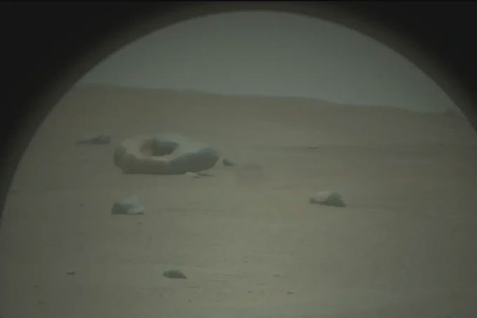 Raw image from the Perseverance rover showing the unusual rock on the surface of Mars