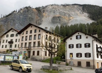 the swiss person had to leave the beautiful village like a painting to attend a party 127529