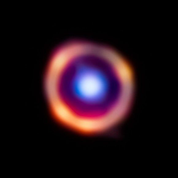Galaxy SPT0418-47 glowing red with organic molecules illuminated by orange light