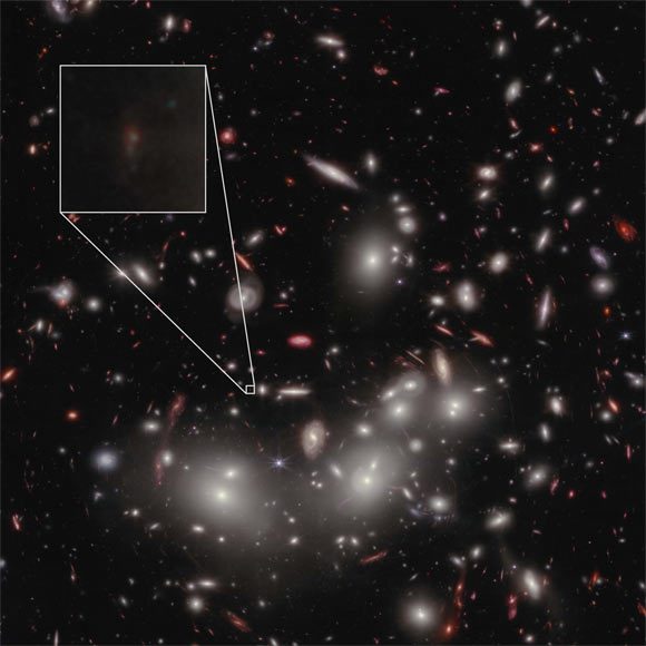 One of the "faces" of the ancient object JD1, magnified by Abell 2733